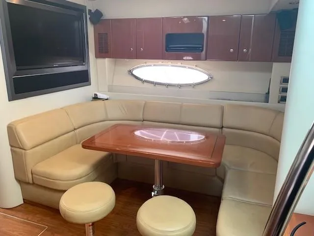 Slide: The Image of Luxurious interior of a 2009 Formula 45 Yacht with leather seating and wooden table. - 19