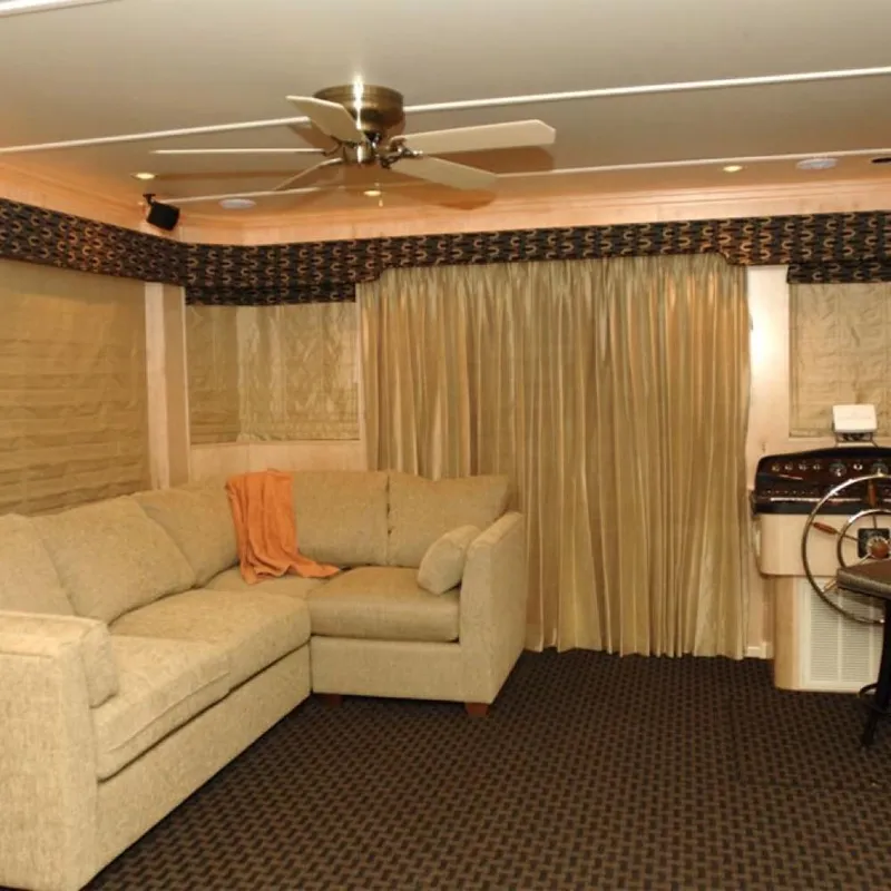 Slide: The Image of Interior of 2006 Sumerset Midnight Magic Trip 2 houseboat with beige sofa and steering wheel. - 8