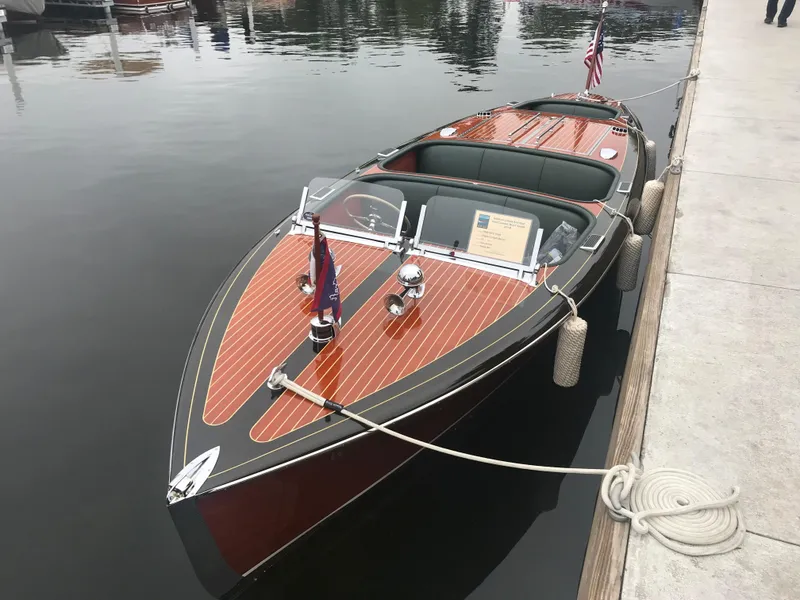 Slide: The Image of 1940 Chris-Craft Deluxe Runabout boat docked on calm water. - 1