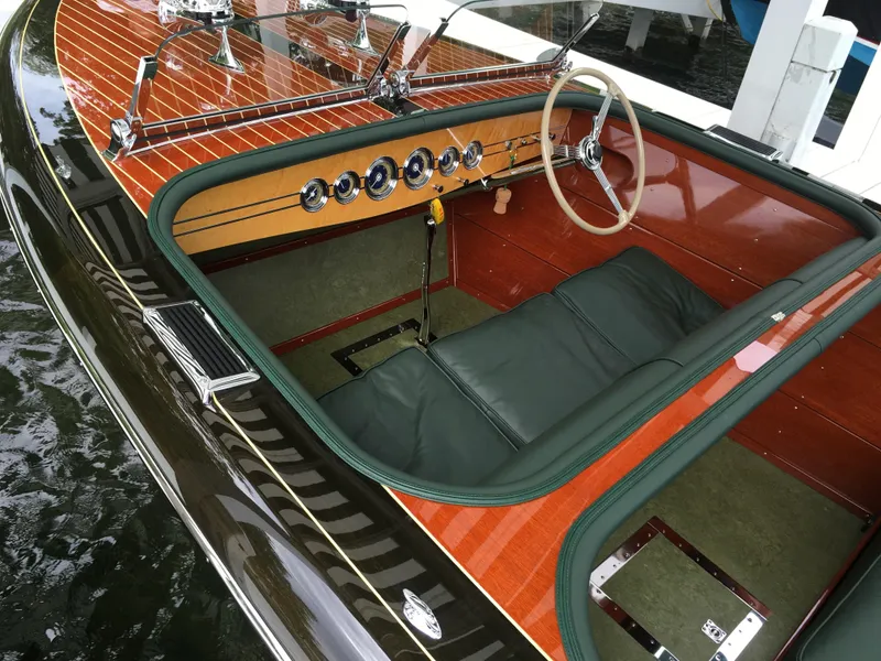 Slide: The Image of 1940 Chris-Craft Deluxe Runabout interior with classic wooden dashboard and steering wheel. - 7