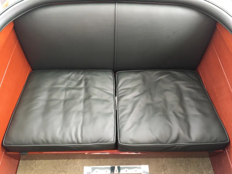 Slide: The Image of 1940 Chris-Craft Deluxe Runabout black leather seating, classic boat interior. - 8