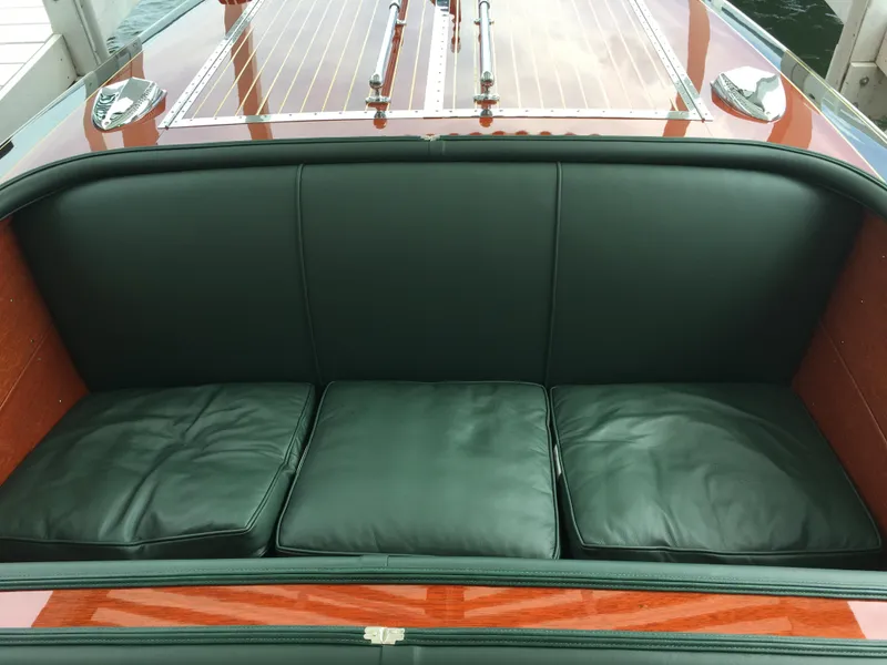 Slide: The Image of 1940 Chris-Craft Deluxe Runabout with green leather seating and polished wooden deck. - 9
