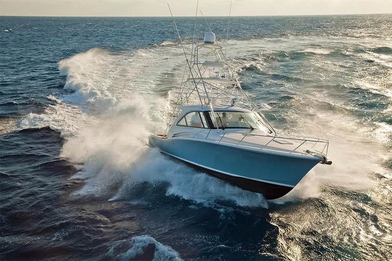 Slide: The Image of 2022 Hatteras GT45X Open cruising on the ocean. - 11