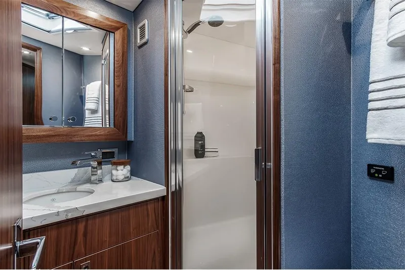 Slide: The Image of 2022 Hatteras GT45X Open yacht bathroom with modern fixtures and wood accents. - 6