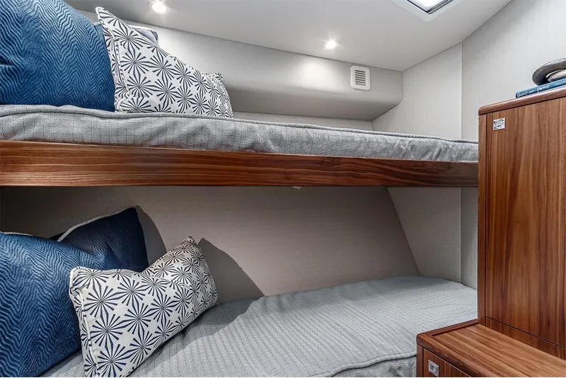 Slide: The Image of 2022 Hatteras GT45X Open cabin with bunk beds and modern decor. - 7