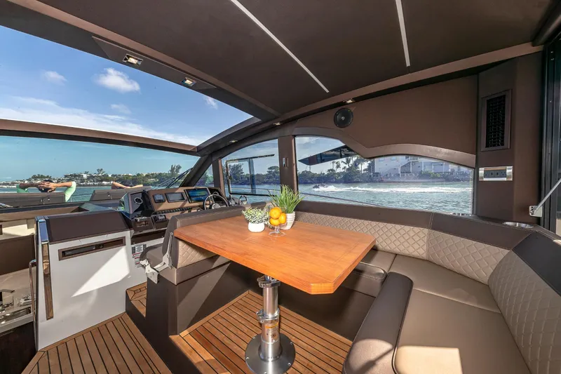 Slide: The Image of Interior of 2023 Galeon 425 HTS yacht with dining area and scenic view. - 12
