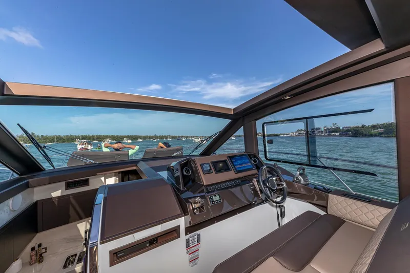 Slide: The Image of 2023 Galeon 425 HTS yacht helm with panoramic water view. - 14