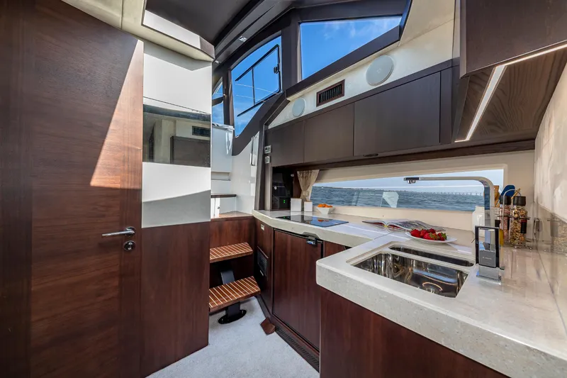Slide: The Image of Modern kitchen interior of 2023 Galeon 425 HTS yacht with ocean view. - 17