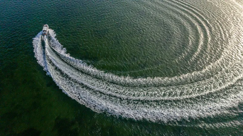 Slide: The Image of Aerial view of 2023 Galeon 425 HTS making a circular wake in the water. - 3