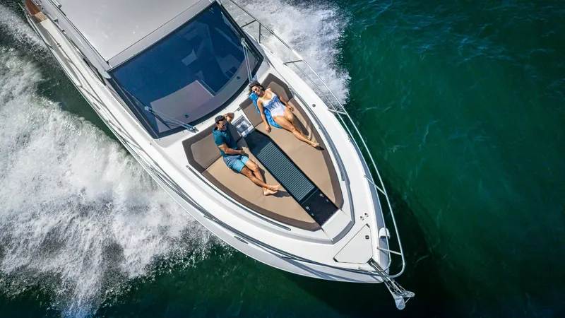 Slide: The Image of 2023 Galeon 425 HTS yacht cruising with two people relaxing on deck. - 4