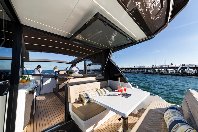 Slide: The Image of 2023 Galeon 425 HTS yacht interior with seating area and ocean view. - 6
