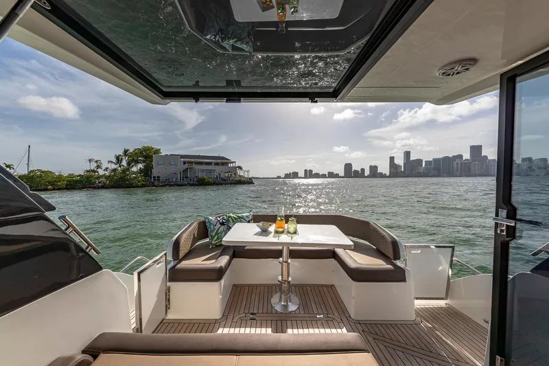 Slide: The Image of 2023 Galeon 425 HTS yacht with scenic waterfront view and city skyline. - 7