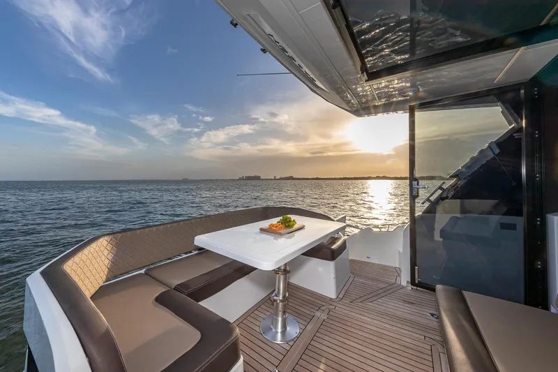 Slide: The Image of 2023 Galeon 425 HTS yacht deck with sunset view over the ocean. - 8