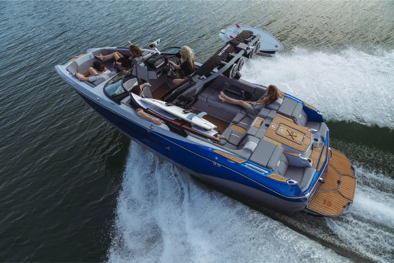 Slide: The Image of 2023 MasterCraft X22 boat cruising on water with passengers. - 0