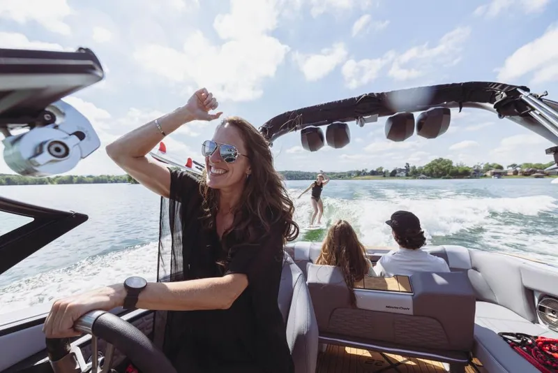 Slide: The Image of 2023 MasterCraft X22 boat with people enjoying water sports. - 11