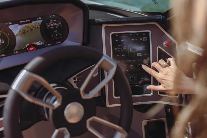 Slide: The Image of 2023 MasterCraft X22 boat dashboard with touchscreen controls and steering wheel. - 14