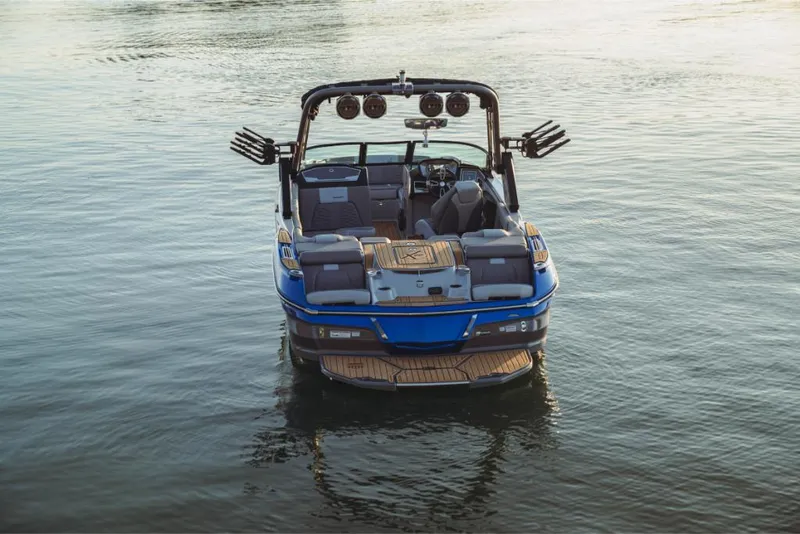 Slide: The Image of 2023 MasterCraft X22 boat on calm water. - 4