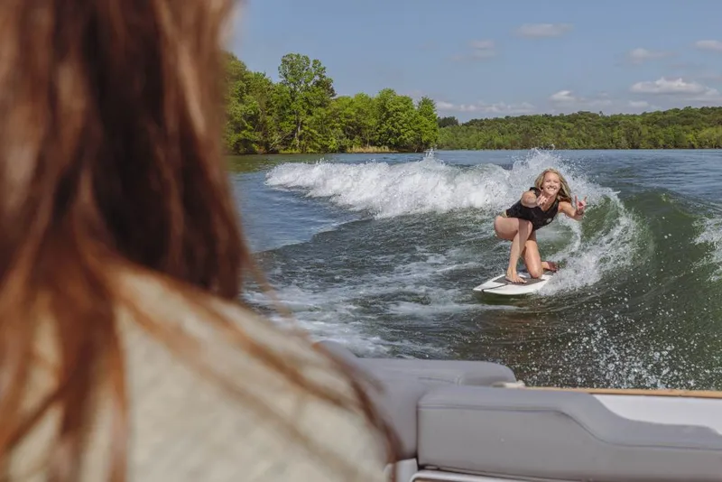 Slide: The Image of 2023 MasterCraft X22 boat towing a wakeboarder on a lake. - 8