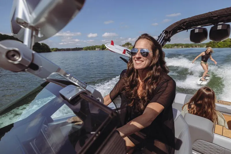 Slide: The Image of 2023 MasterCraft X22 boat with people enjoying water sports. - 9