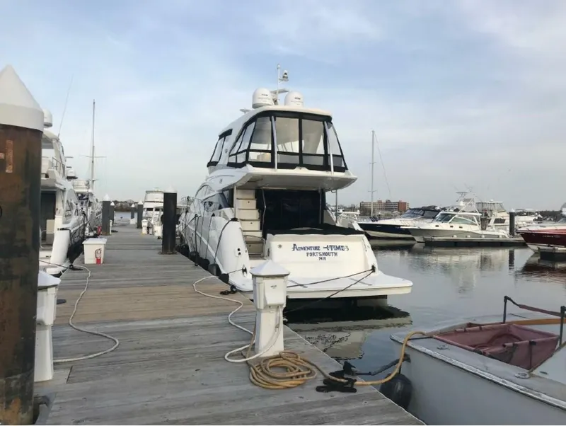 Slide: The Image of 2016 Sea Ray L590 Fly yacht docked at marina. - 2