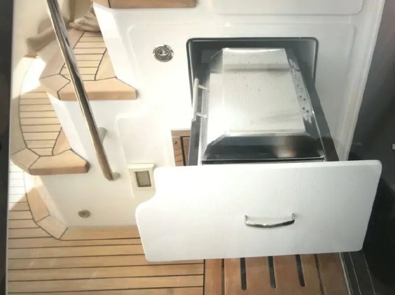 Slide: The Image of 2016 Sea Ray L590 Fly yacht interior with open drawer and wooden steps. - 3