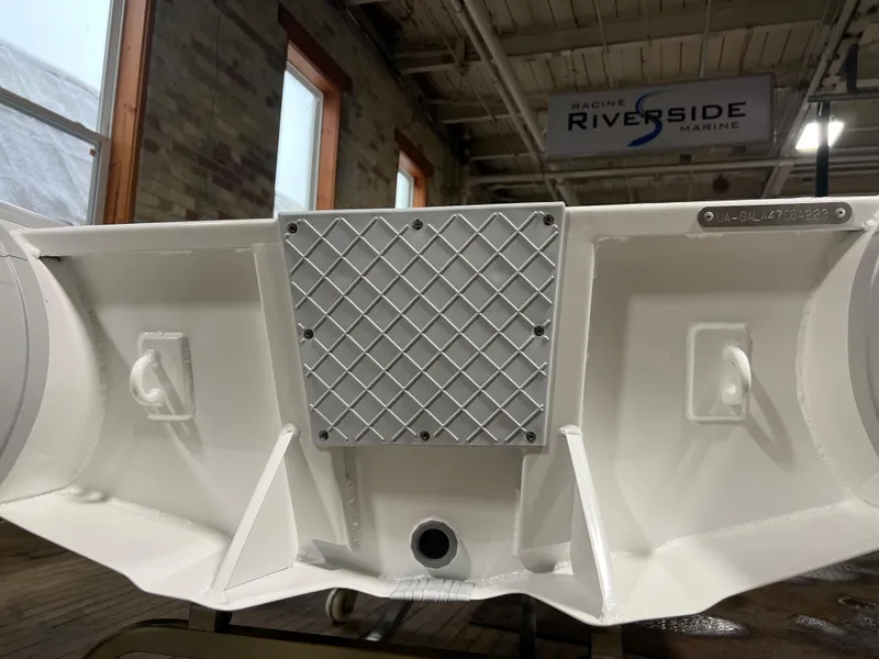 Slide: The Image of 2023 Gala A270 LITE boat transom in a workshop with Riverside Marine sign. - 11