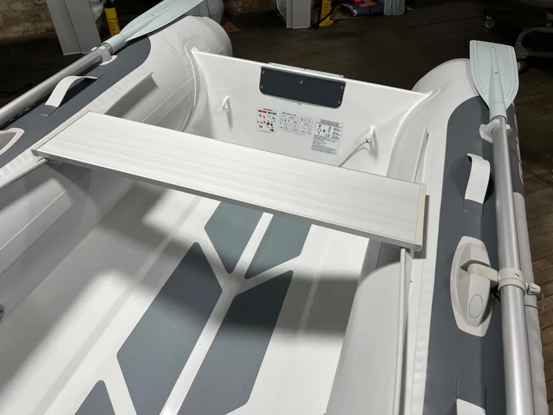 Slide: The Image of 2023 Gala A270 LITE inflatable boat interior with bench seat and oars. - 5