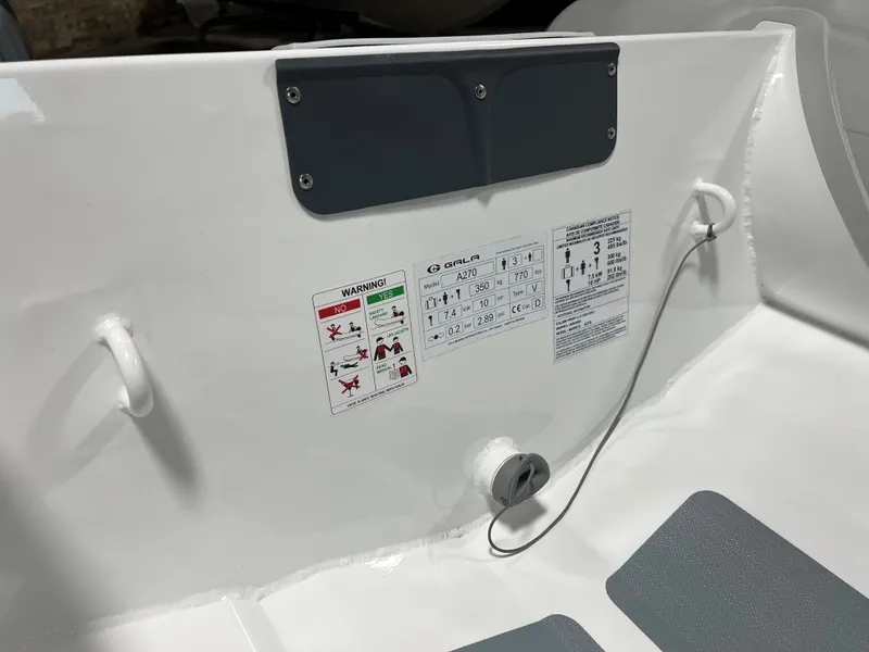 Slide: The Image of 2023 Gala A270 LITE boat interior with safety and instruction labels. - 9