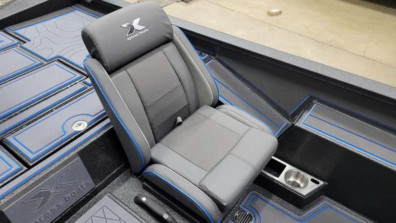 Slide: The Image of 2025 Xpress X21 Pro Bass boat interior with premium seating and storage compartments. - 10