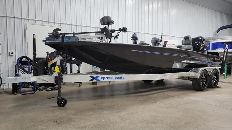 Slide: The Image of 2025 Xpress X21 Pro Bass boat with Yamaha Vmax 250, in stock, displayed indoors. - 11