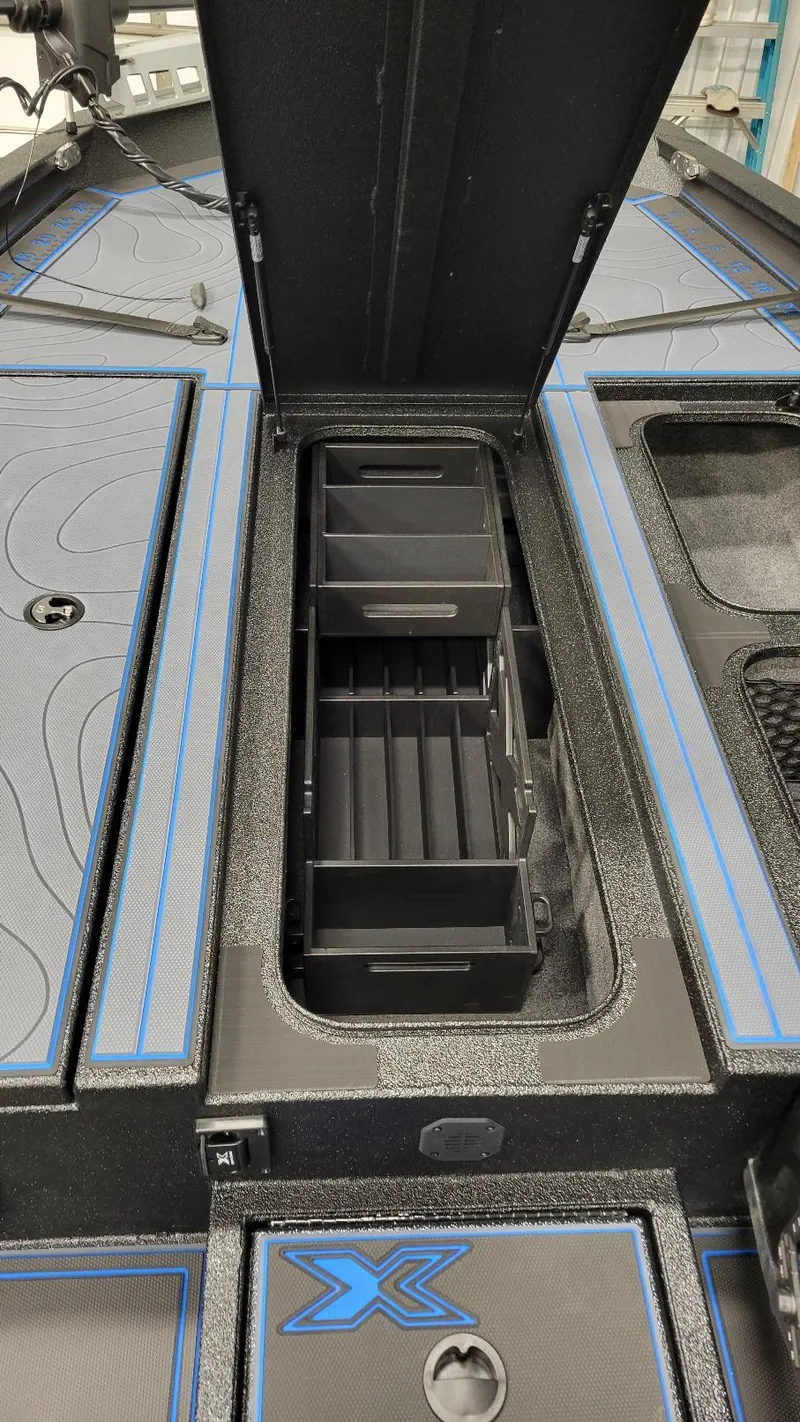Slide: The Image of 2025 Xpress X21 Pro Bass boat storage compartment with Yamaha Vmax 250 engine. - 16