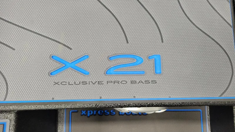Slide: The Image of 2025 Xpress X21 Pro Bass boat floor with blue logo detailing. - 18