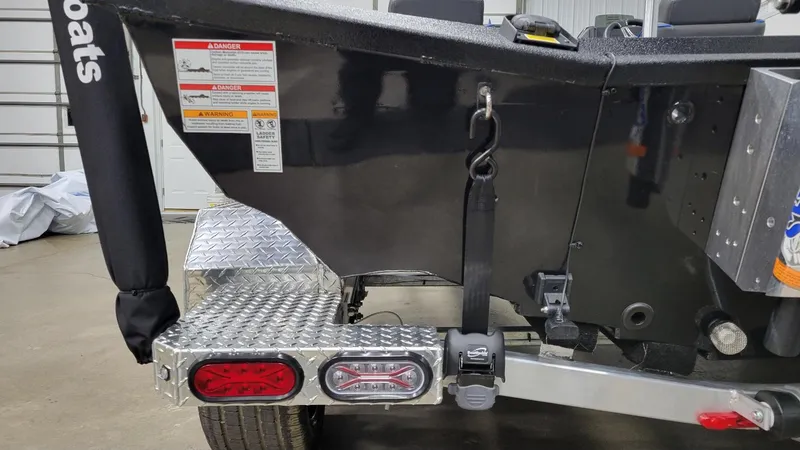 Slide: The Image of Rear view of 2025 Xpress X21 Pro Bass boat trailer with safety features. - 4