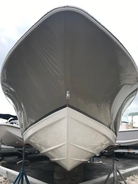 Slide: The Image of 2019 NauticStar 2302 LDC boat hull, front view, on stands. - 1