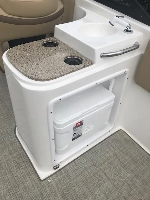 Slide: The Image of 2019 NauticStar 2302 LDC boat interior with sink and storage area. - 10