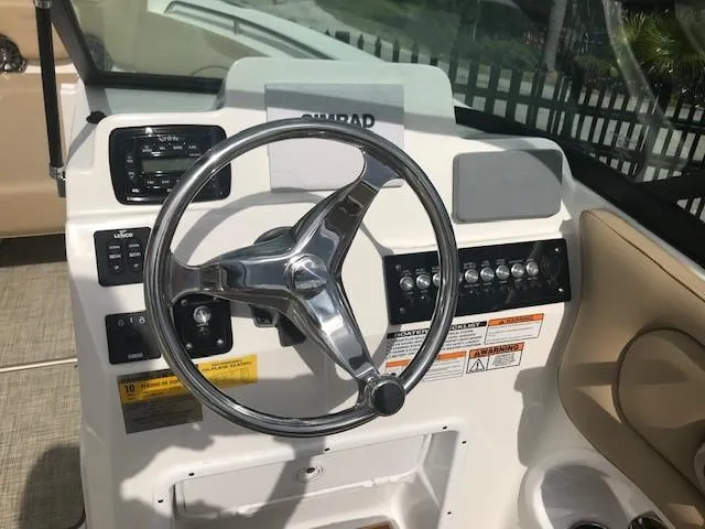 Slide: The Image of 2019 NauticStar 2302 LDC boat dashboard with steering wheel and control panel. - 15