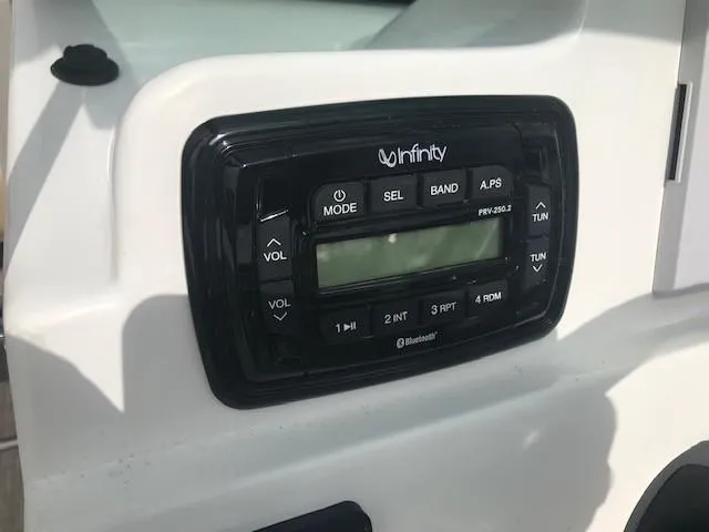 Slide: The Image of Infinity stereo system on 2019 NauticStar 2302 LDC boat dashboard. - 18