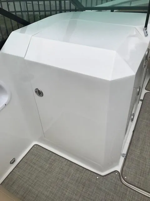 Slide: The Image of 2019 NauticStar 2302 LDC boat interior, featuring sleek white console design. - 26