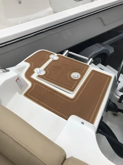 Slide: The Image of 2019 NauticStar 2302 LDC boat deck with brown non-slip surface. - 28