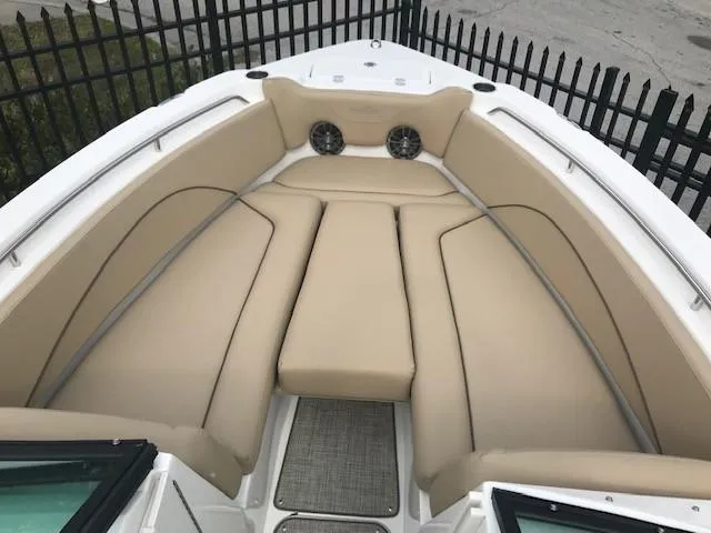 Slide: The Image of 2019 NauticStar 2302 LDC boat with beige cushioned seating and speakers. - 4