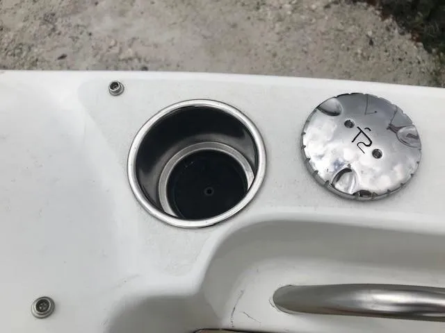 Slide: The Image of Close-up of 2019 NauticStar 2302 LDC boat cup holder and fuel cap. - 41