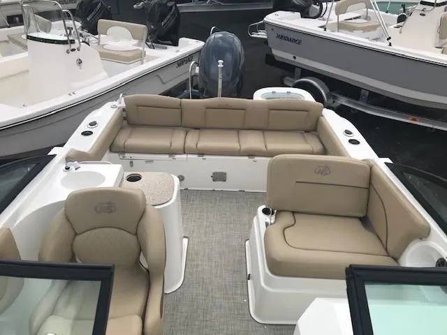 Slide: The Image of 2019 NauticStar 2302 LDC boat interior with beige seating and modern design. - 5