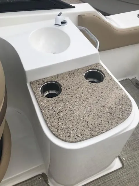 Slide: The Image of 2019 NauticStar 2302 LDC boat console with sink and cup holders. - 9