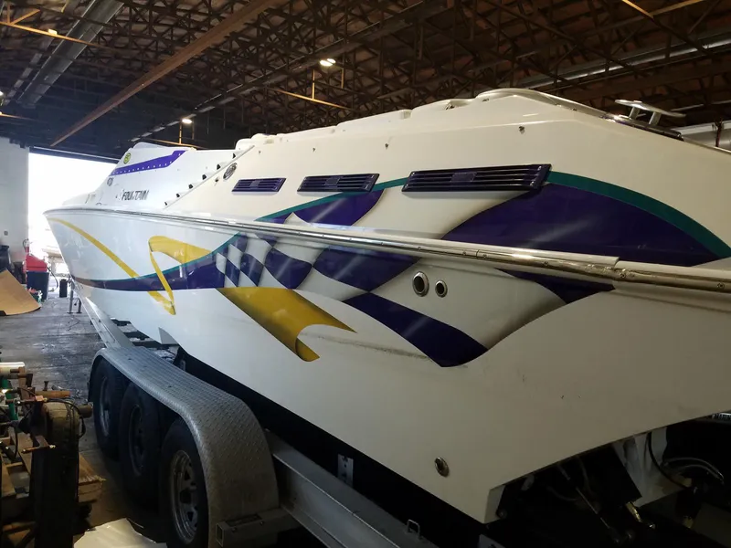 Slide: The Image of 2008 Fountain 42 Executioner speedboat with vibrant graphics in a warehouse setting. - 21