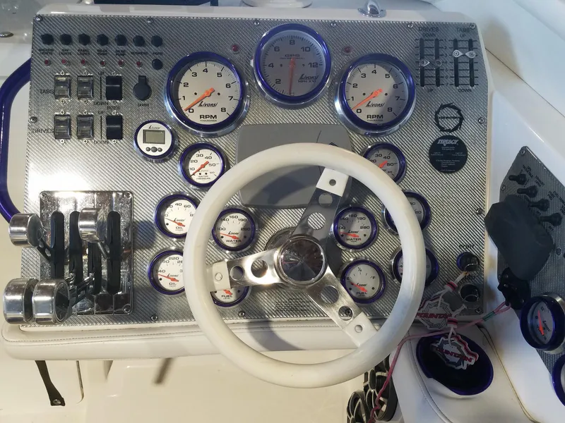 Slide: The Image of Dashboard of a 2008 Fountain 42 Executioner boat with gauges and controls. - 3