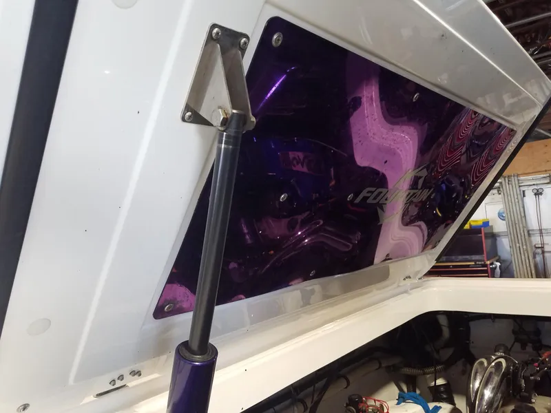 Slide: The Image of 2008 Fountain 42 Executioner engine compartment with purple accents and hydraulic lift. - 31