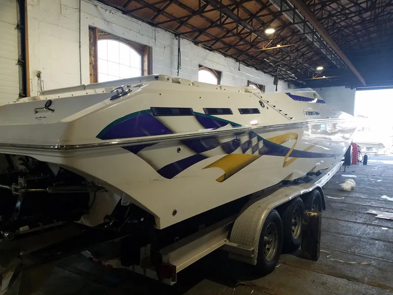 Slide: The Image of 2008 Fountain 42 Executioner speedboat with vibrant graphics in a warehouse setting. - 38