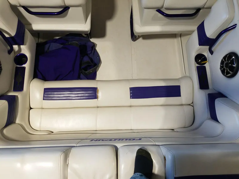 Slide: The Image of Interior of a 2008 Fountain 42 Executioner boat with white and blue seating. - 40