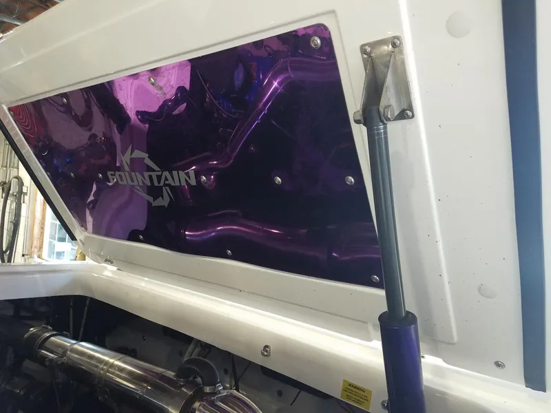 Slide: The Image of 2008 Fountain 42 Executioner engine compartment with purple accents and hydraulic lift. - 43