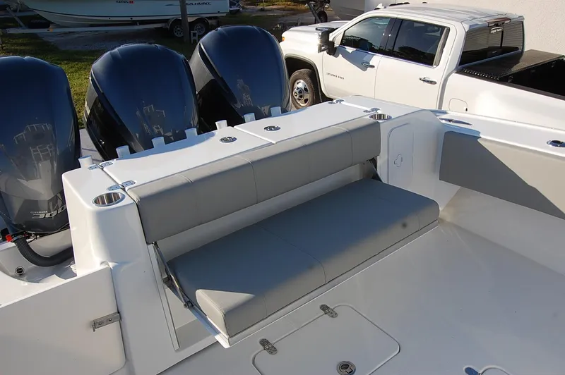 Slide: The Image of 2025 Cape Horn 36 XS boat with triple outboard engines and foldable rear seating. - 13